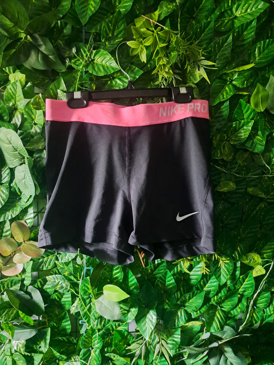 Short de sport noir avec bande rose Nike