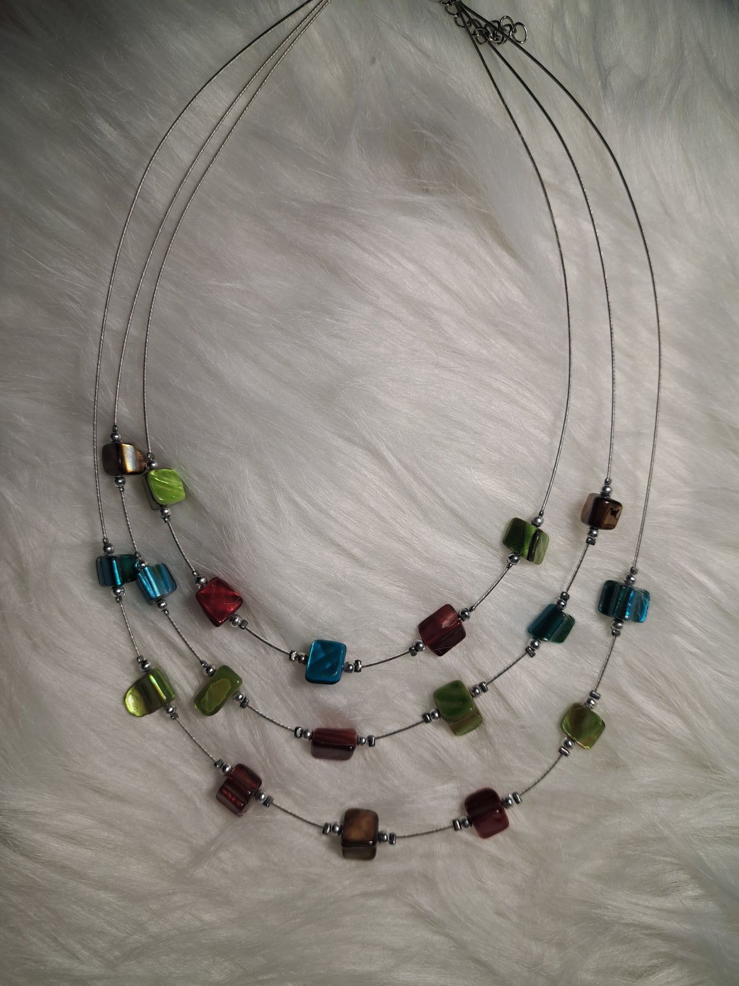 Collier en fils de pêche avec pierres rouges, vertes et bleues